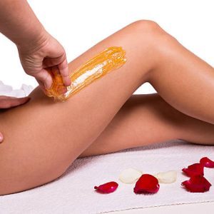 Sugaring: epilation with liquate sugar at legs. Sugaring: epilation with liquate sugar at legs.